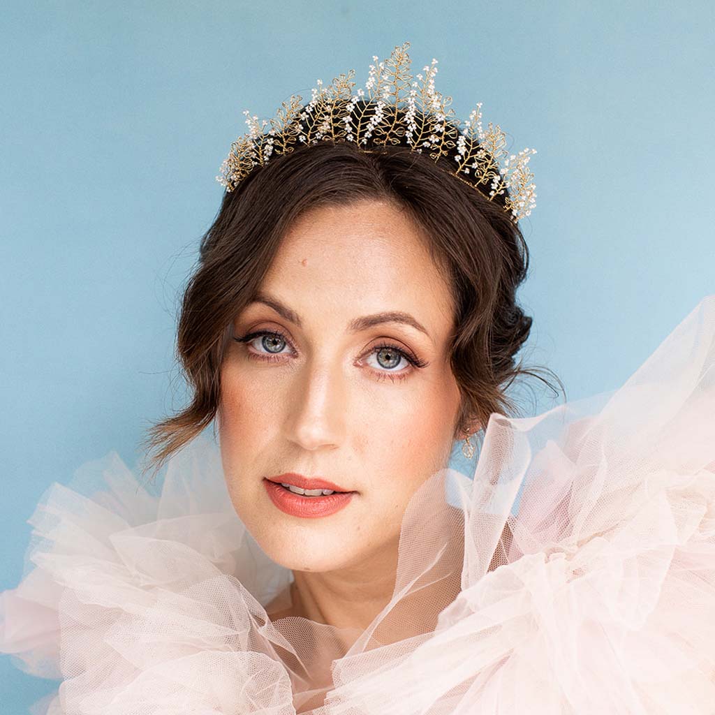 Model hearing gold wire and ivory beaded wedding headband by Judith Brown Bridal