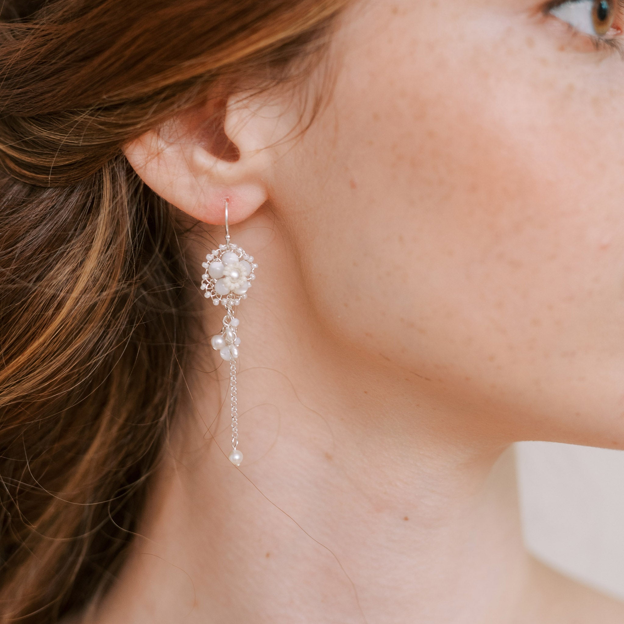 Close up of the Ginevra drop earrings in mother of pearl and silver by Judith Brown Bridal