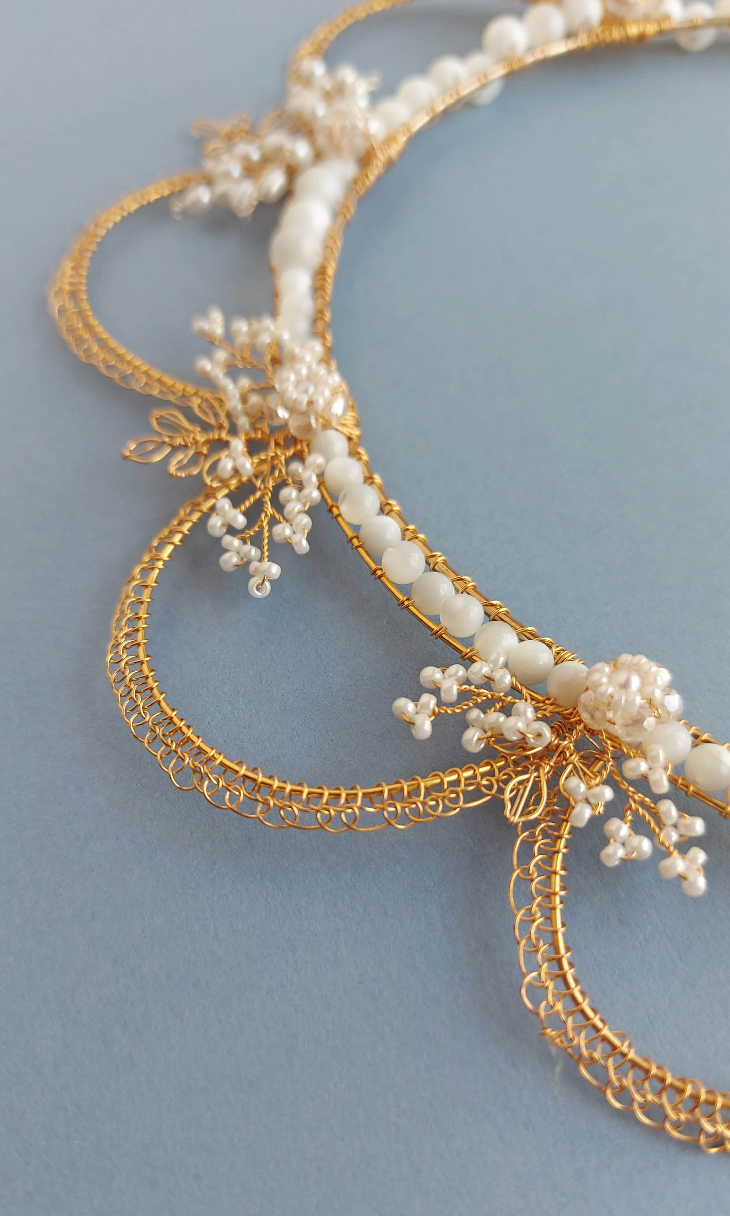 Close up of the Oriana crown in gold and mother of pearl beads
