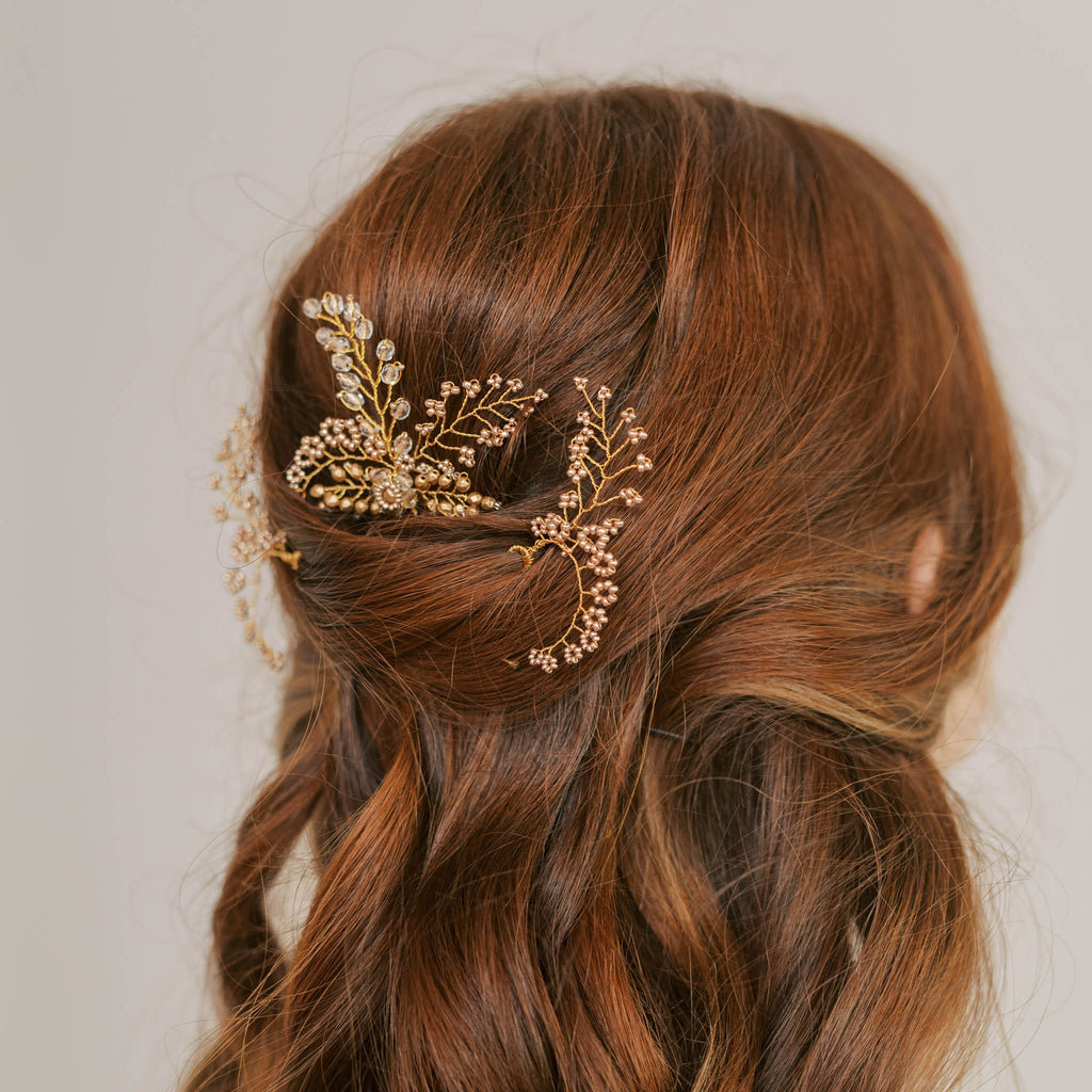 Side view of a trio of golden wedding hair pins by Judith Brown Bridal