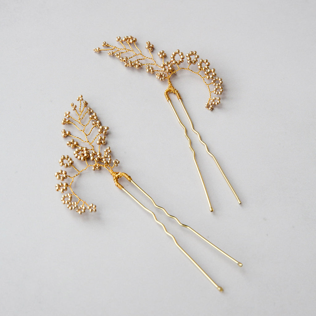 pair of Farfalla bridal hair pins in gold by Judith Brown Bridal
