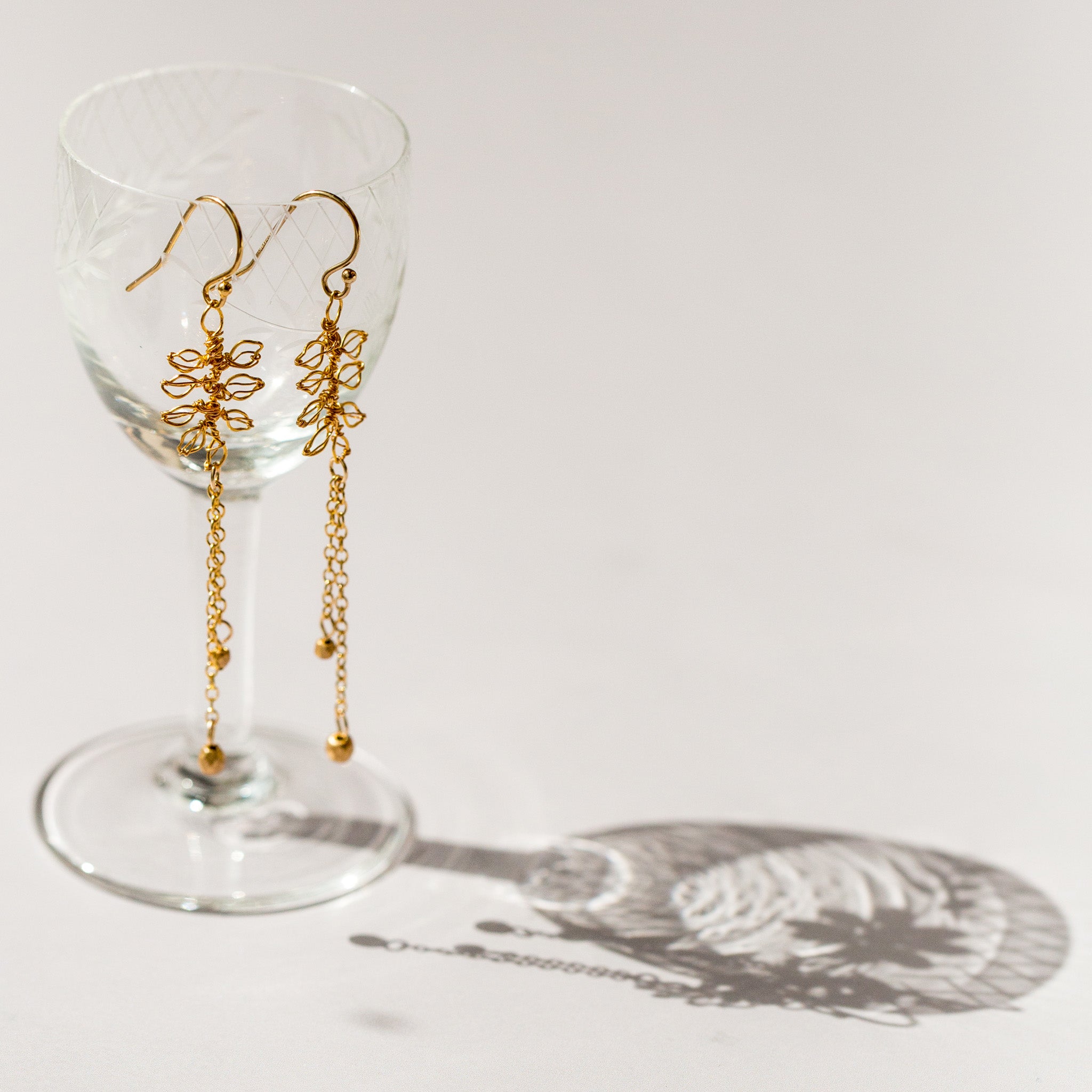 Tiny handmade leaf earrings in gold wire by Judith Brown Bridal